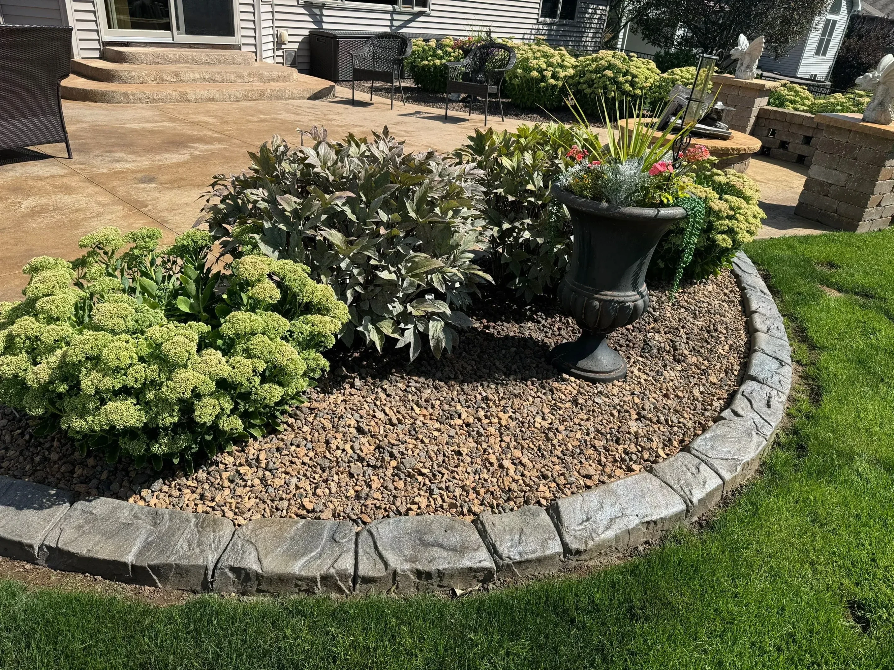 Professional landscape curbing along a residential flower bed in East Moline, Illinois